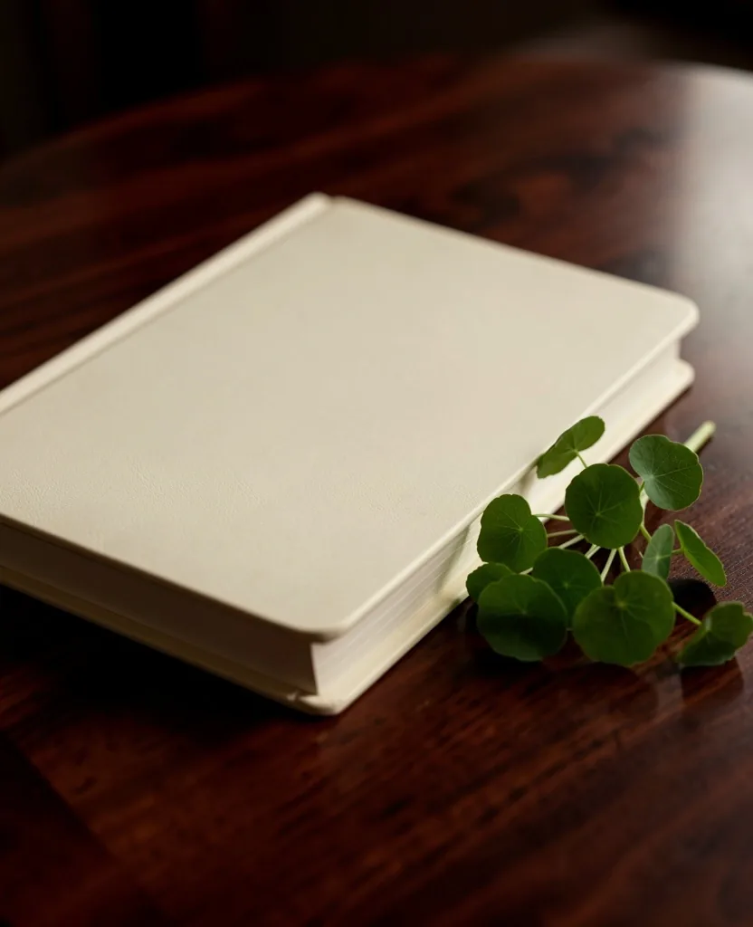 Notebook with herb on a dark desk